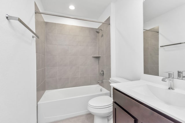 full bathroom with toilet, tiled shower / bath combo, tile patterned flooring, and vanity