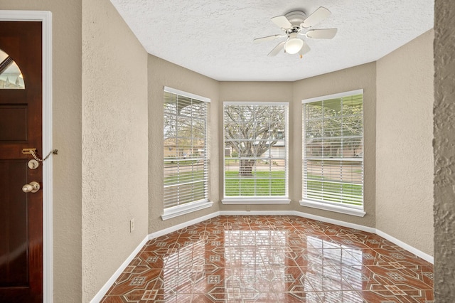 interior space with ceiling fan and a healthy amount of sunlight