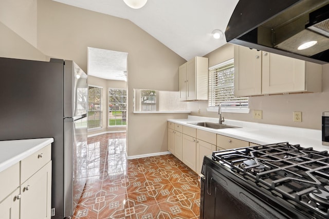 kitchen featuring stainless steel fridge, extractor fan, sink, light tile patterned floors, and lofted ceiling