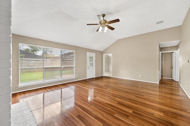 unfurnished living room featuring hardwood / wood-style flooring, ceiling fan, a textured ceiling, and vaulted ceiling