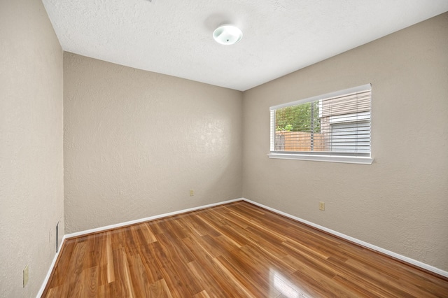 spare room featuring hardwood / wood-style floors