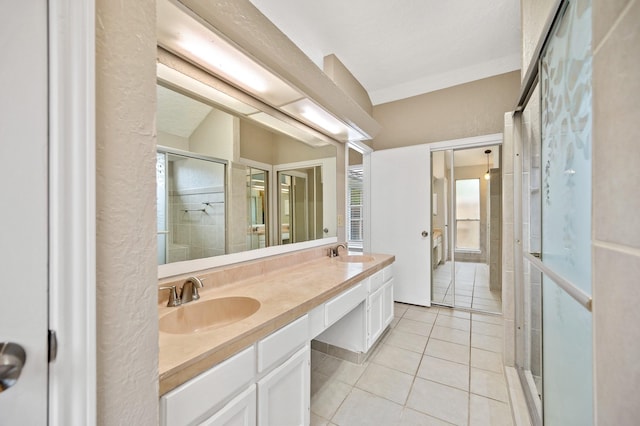 bathroom featuring tile patterned floors, vanity, and a shower with shower door