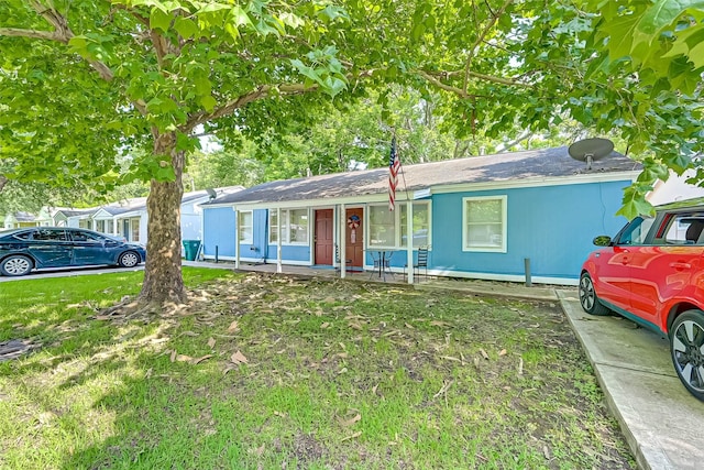 ranch-style home with a front lawn