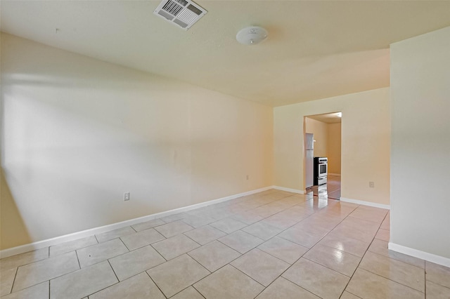 spare room with light tile patterned floors