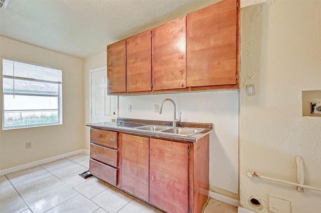 kitchen with sink and light tile patterned floors