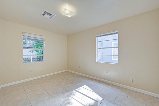 unfurnished room featuring light tile patterned floors