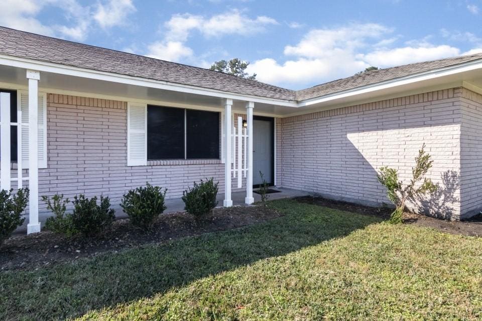 doorway to property with a yard