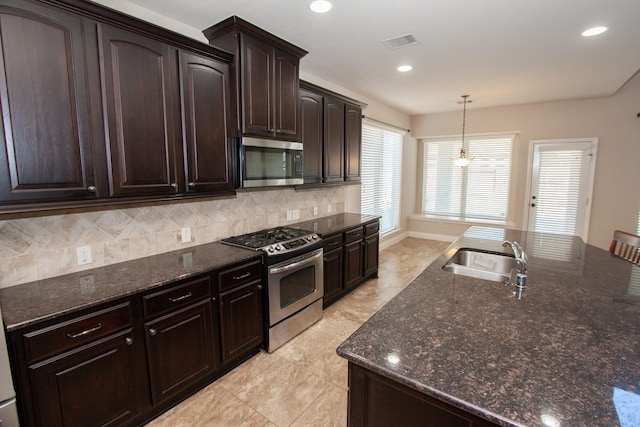 kitchen with sink, tasteful backsplash, decorative light fixtures, dark brown cabinetry, and stainless steel appliances