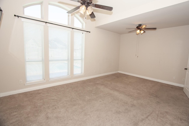 carpeted empty room featuring vaulted ceiling and ceiling fan