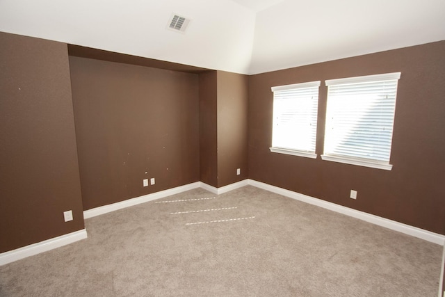 spare room featuring light colored carpet