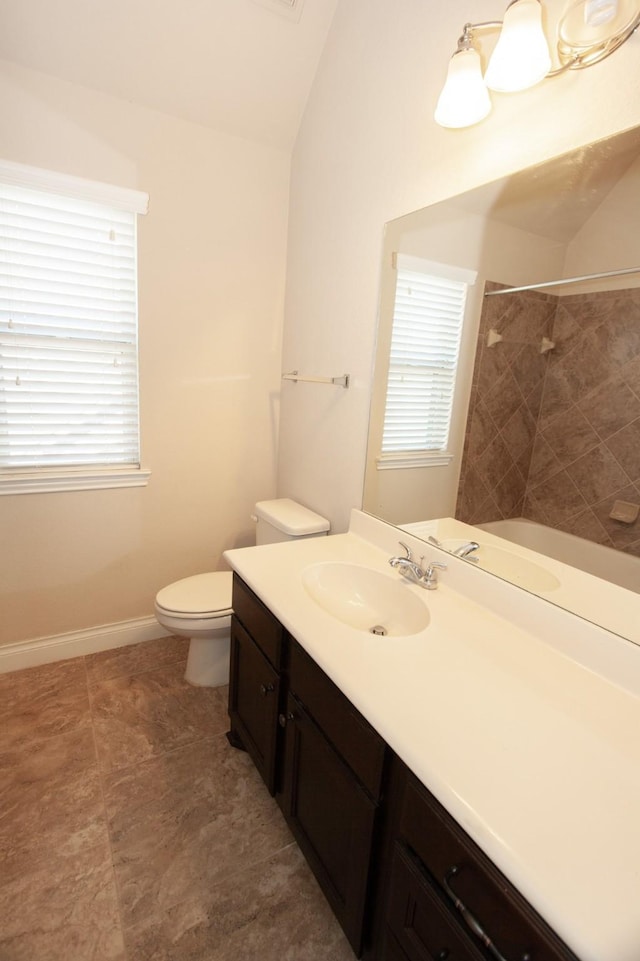 bathroom with vanity, vaulted ceiling, and toilet