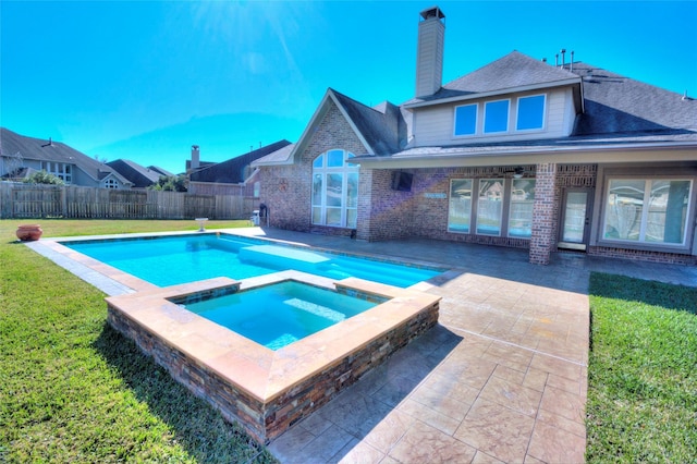 view of swimming pool with a lawn, an in ground hot tub, and a patio