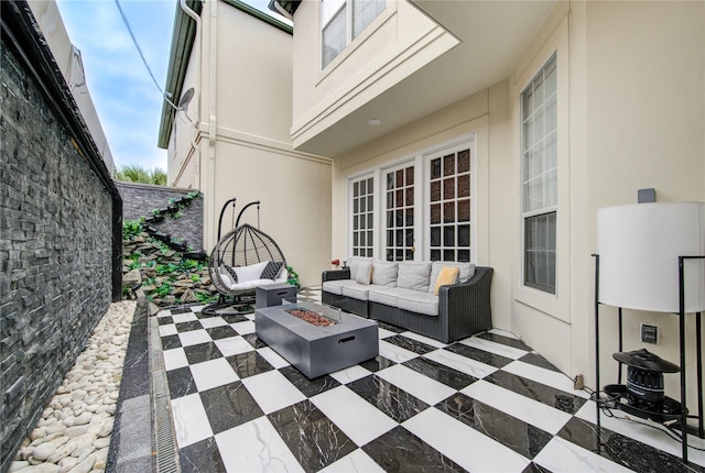 view of patio / terrace with an outdoor living space with a fire pit