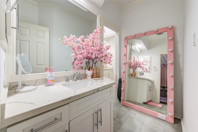 bathroom featuring vanity, tile patterned floors, and crown molding