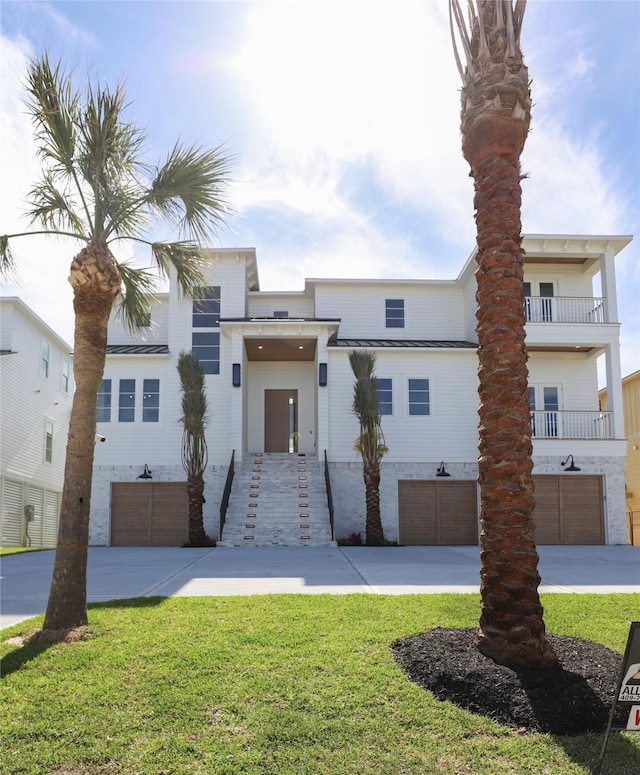 view of front of house with a front yard and a garage