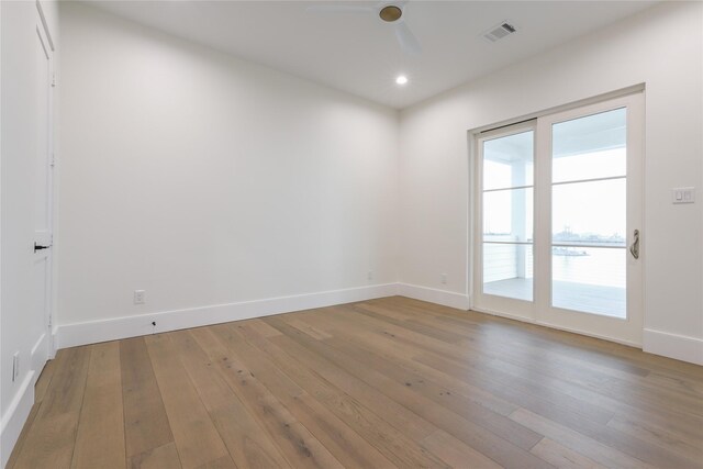 unfurnished room with ceiling fan and light wood-type flooring