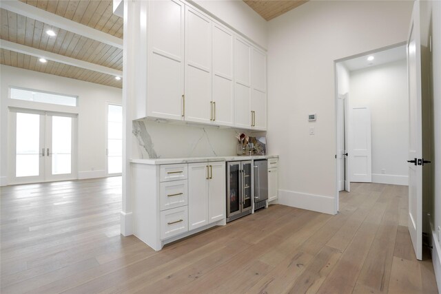 kitchen with white cabinets, beamed ceiling, light hardwood / wood-style floors, wood ceiling, and wine cooler