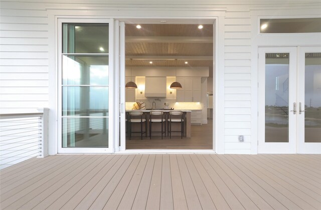 deck featuring french doors and sink