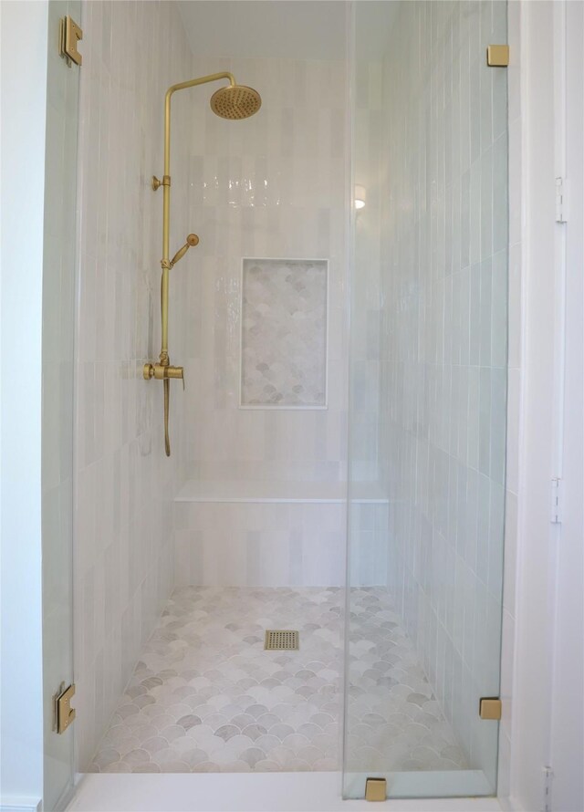 bathroom with a shower with door