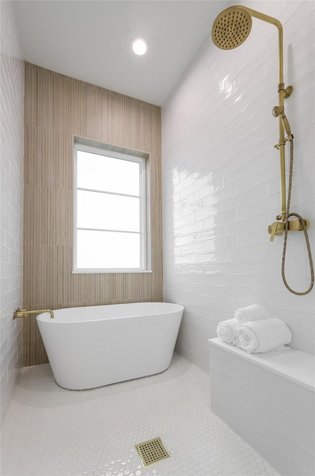 bathroom with independent shower and bath and tile patterned floors