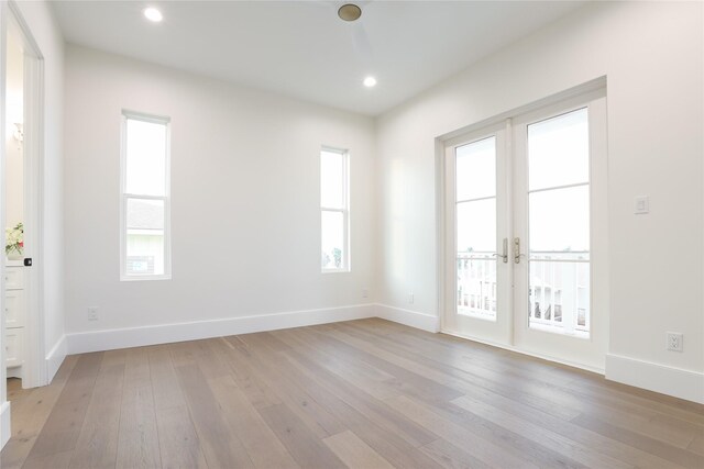 unfurnished room with french doors, light hardwood / wood-style flooring, and a wealth of natural light