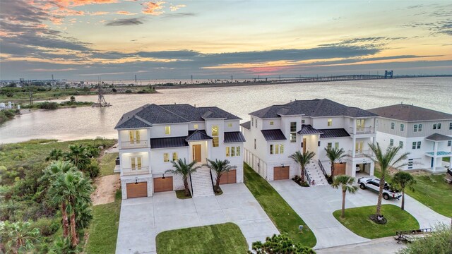 aerial view at dusk with a water view