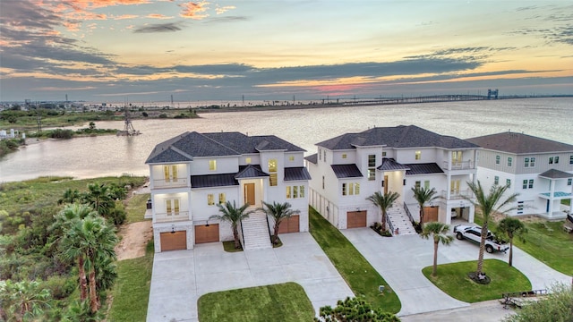 aerial view at dusk with a water view