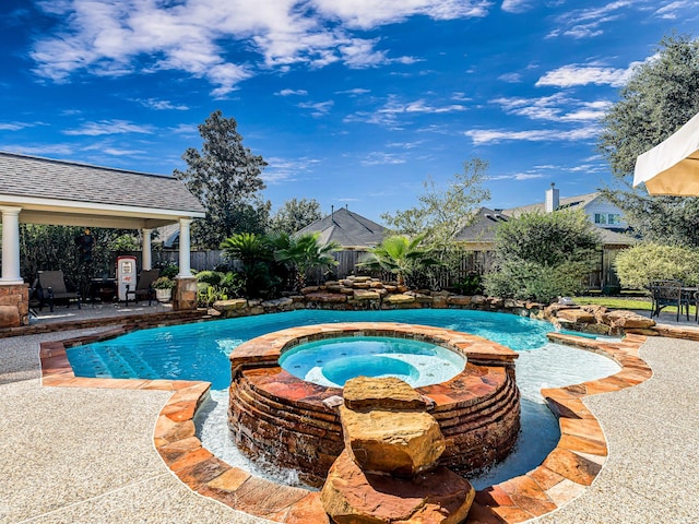 view of pool featuring an in ground hot tub and a patio