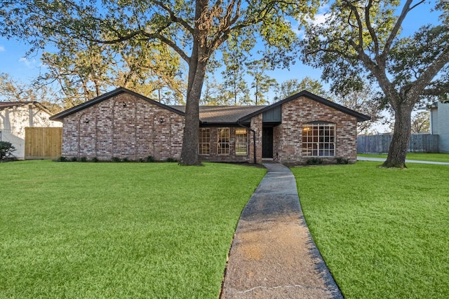 ranch-style home with a front lawn