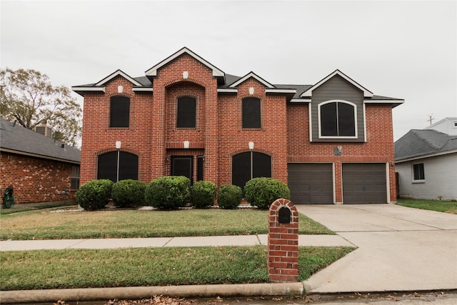 front facade featuring a front yard and a garage