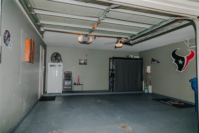 garage with white fridge and a garage door opener