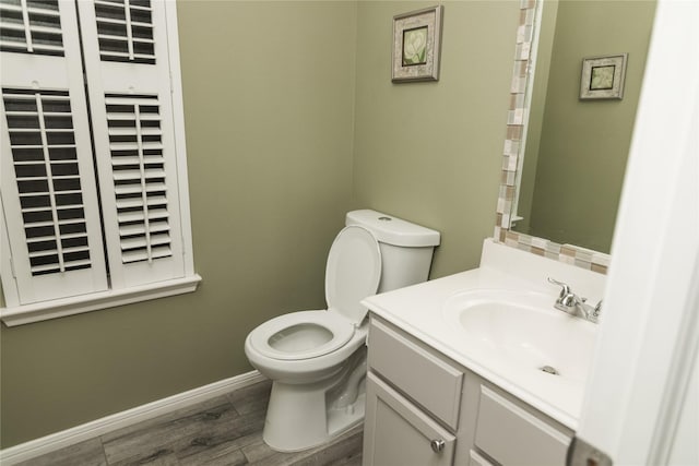 bathroom featuring wood-type flooring, vanity, and toilet