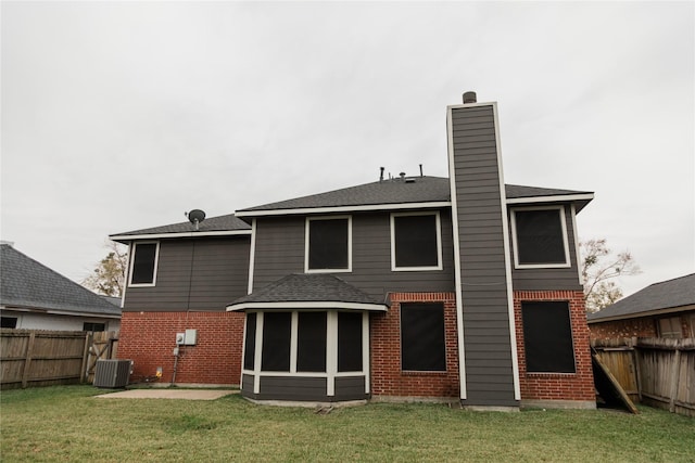 back of property featuring a patio, central air condition unit, a sunroom, and a lawn