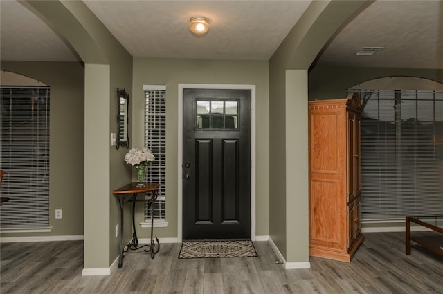 entrance foyer featuring a textured ceiling and hardwood / wood-style flooring