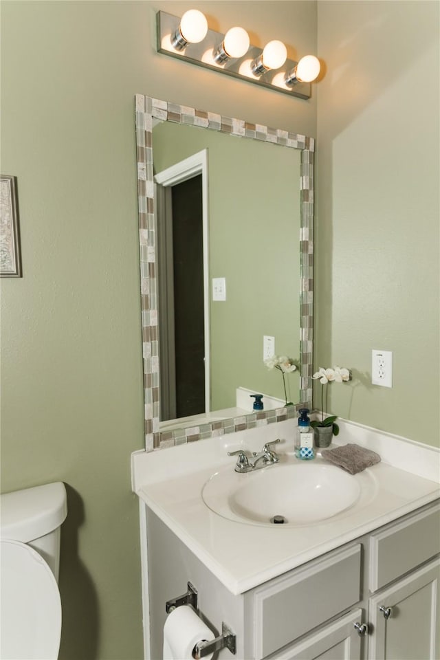 bathroom featuring toilet and vanity