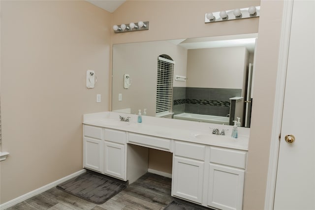 bathroom with vanity, a bathtub, and hardwood / wood-style floors