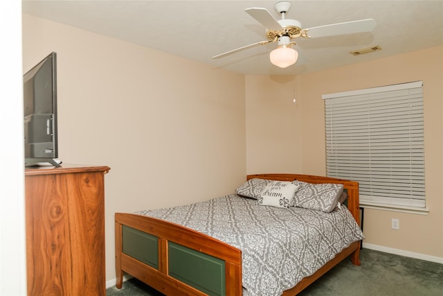 bedroom with dark colored carpet and ceiling fan