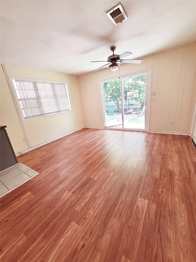 unfurnished living room featuring ceiling fan and light hardwood / wood-style floors