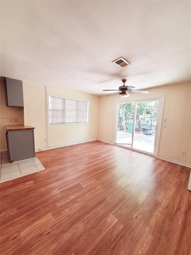 unfurnished living room featuring ceiling fan and light hardwood / wood-style flooring