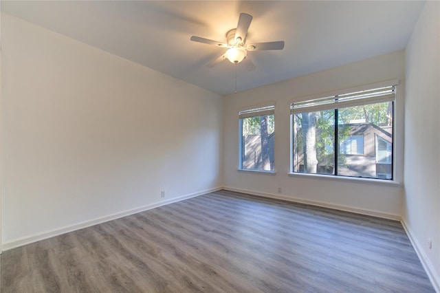 empty room featuring ceiling fan and hardwood / wood-style flooring