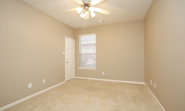 unfurnished room featuring light colored carpet and ceiling fan