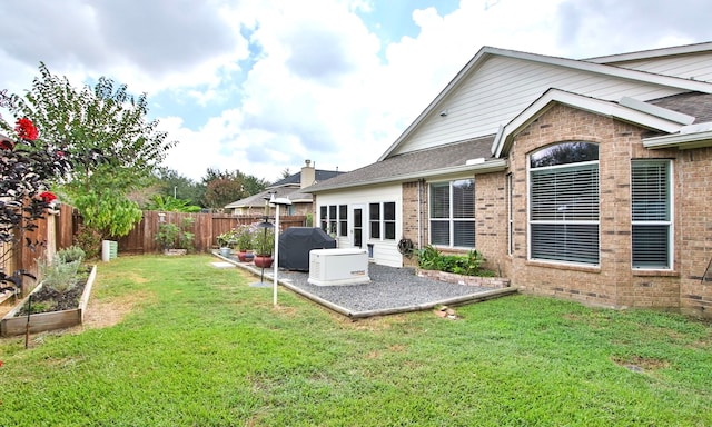 rear view of property featuring a yard