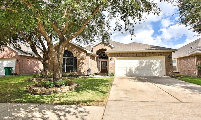 ranch-style home with a garage and a front yard