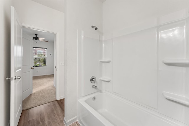 bathroom featuring hardwood / wood-style floors, ceiling fan, and shower / bathtub combination