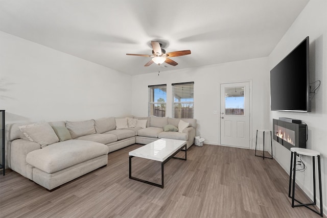 living room featuring light wood-type flooring and ceiling fan