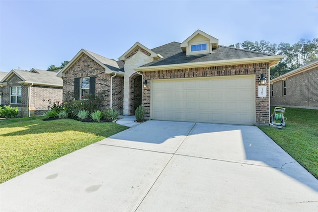 view of front of home featuring a garage and a front lawn