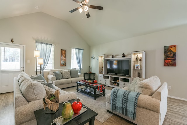 living room featuring light hardwood / wood-style flooring, ceiling fan, and lofted ceiling