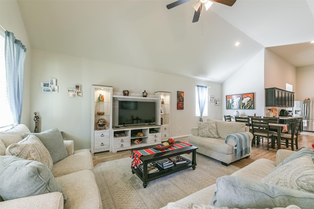 living room featuring light wood-type flooring, high vaulted ceiling, and ceiling fan