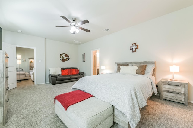 carpeted bedroom featuring ceiling fan and ensuite bathroom