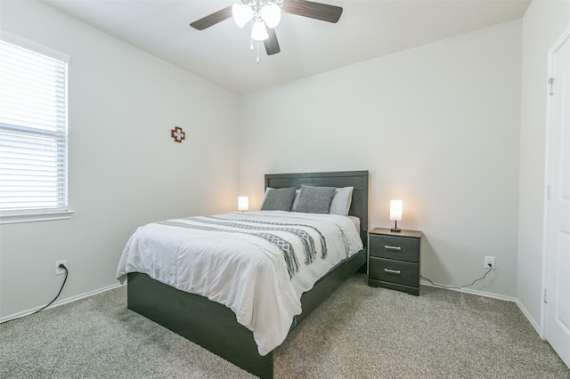 bedroom featuring light colored carpet and ceiling fan